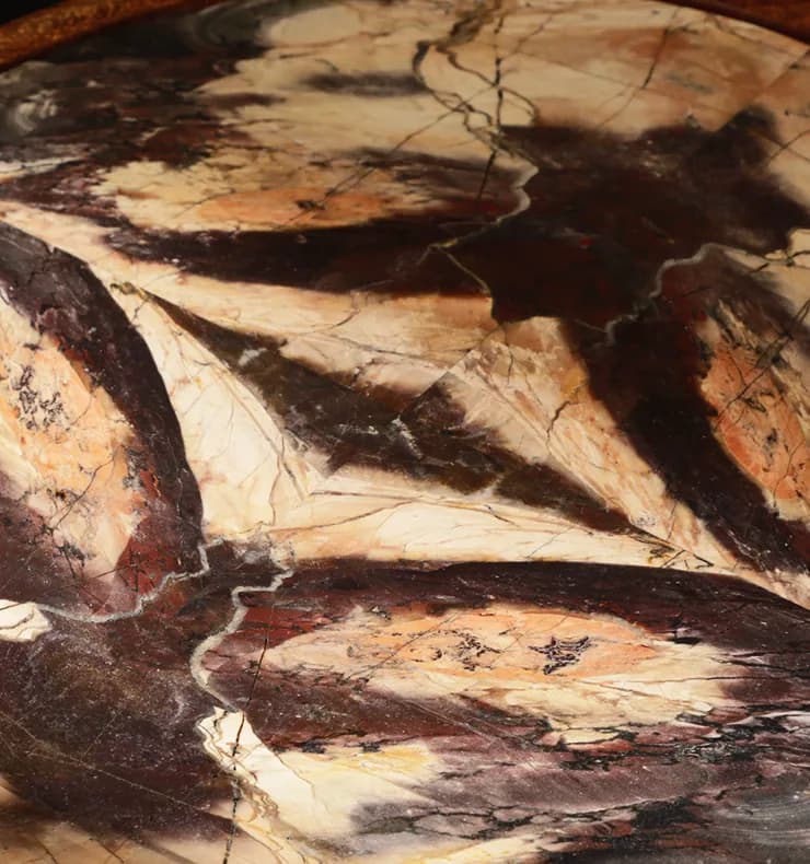 Close detail of richly veined coloured stone, hand-carved.